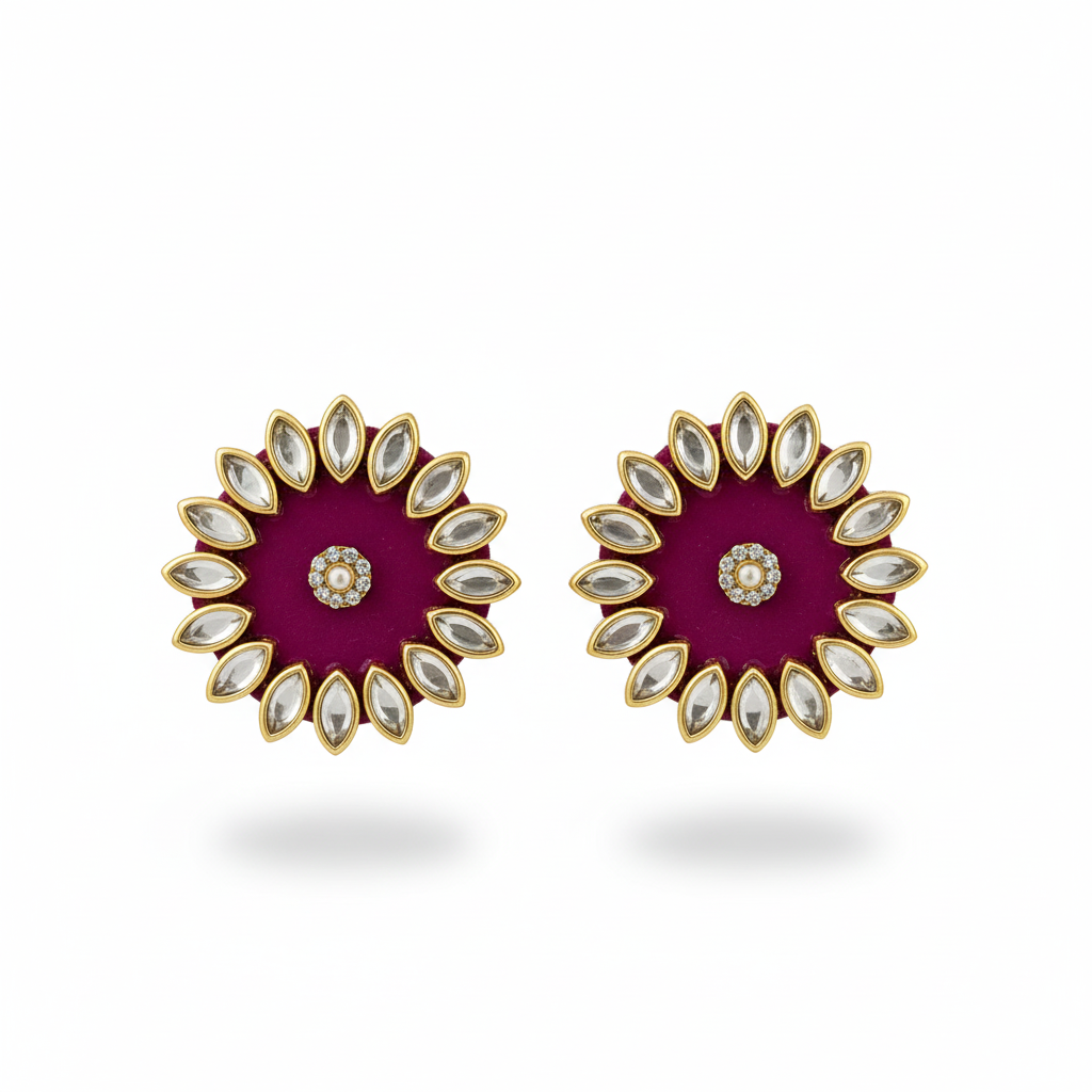 Pair of earrings with a purple center and gold and white accents on a white background