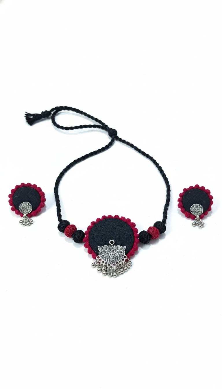 Black and red beaded necklace with silver pendant on a white background