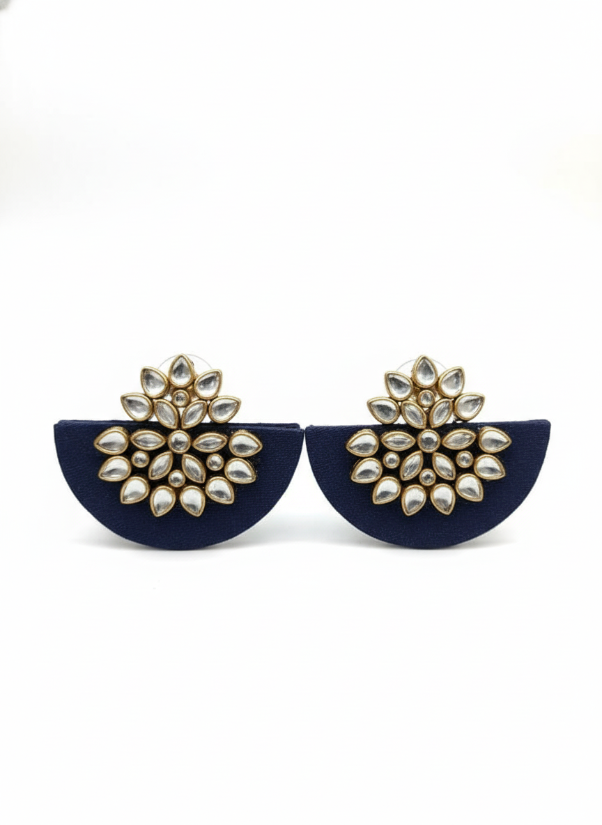 Navy blue earrings with gold and pearl-like embellishments on a white background