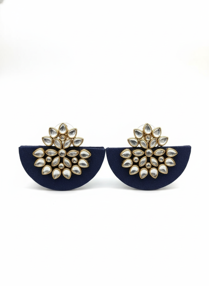 Navy blue earrings with gold and pearl-like embellishments on a white background