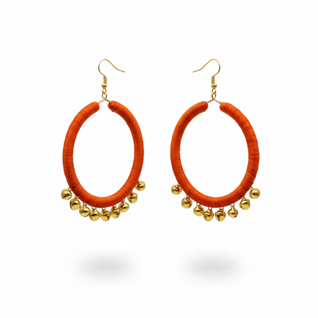 Orange hoop earrings with gold beads on a white background