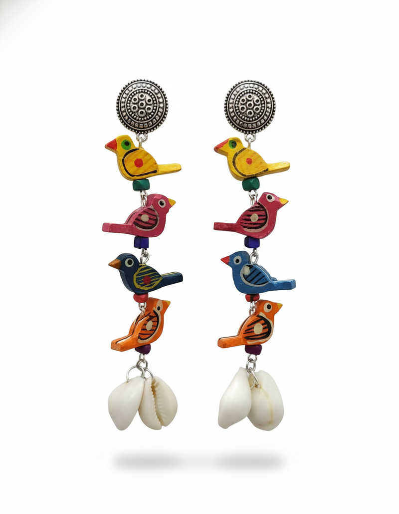 Colorful bird-shaped earrings with cowrie shells on a white background