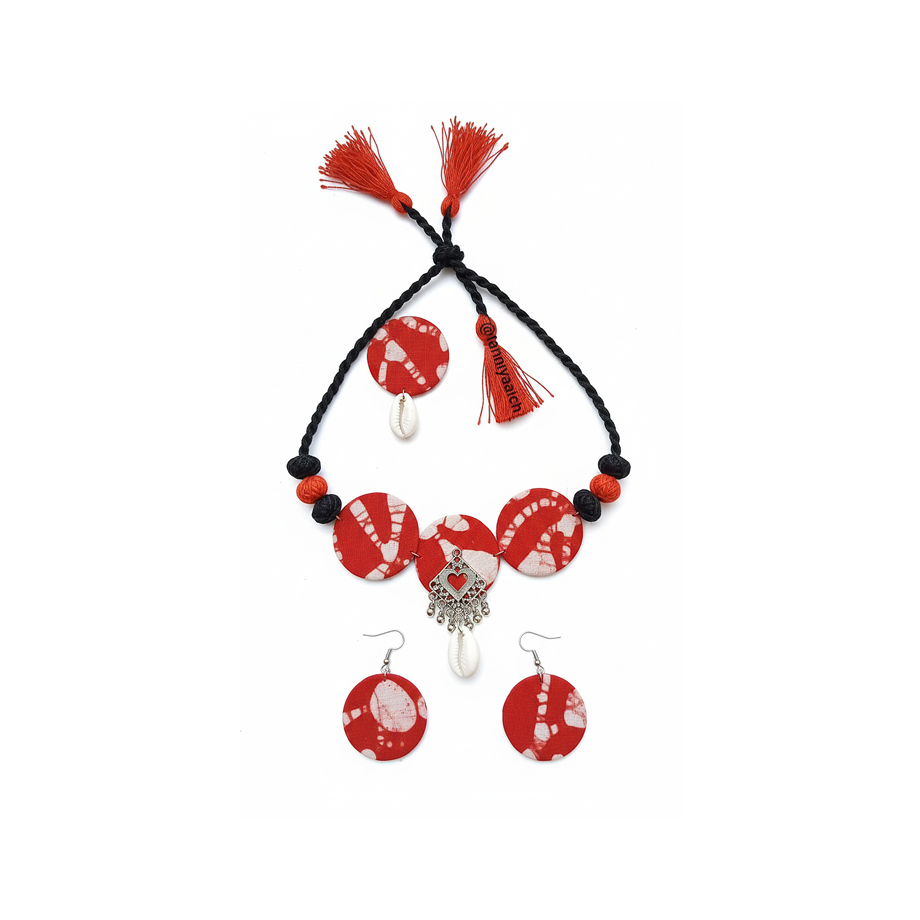Jewelry set with red and white heart-themed beads on a black cord, including a necklace and earrings.